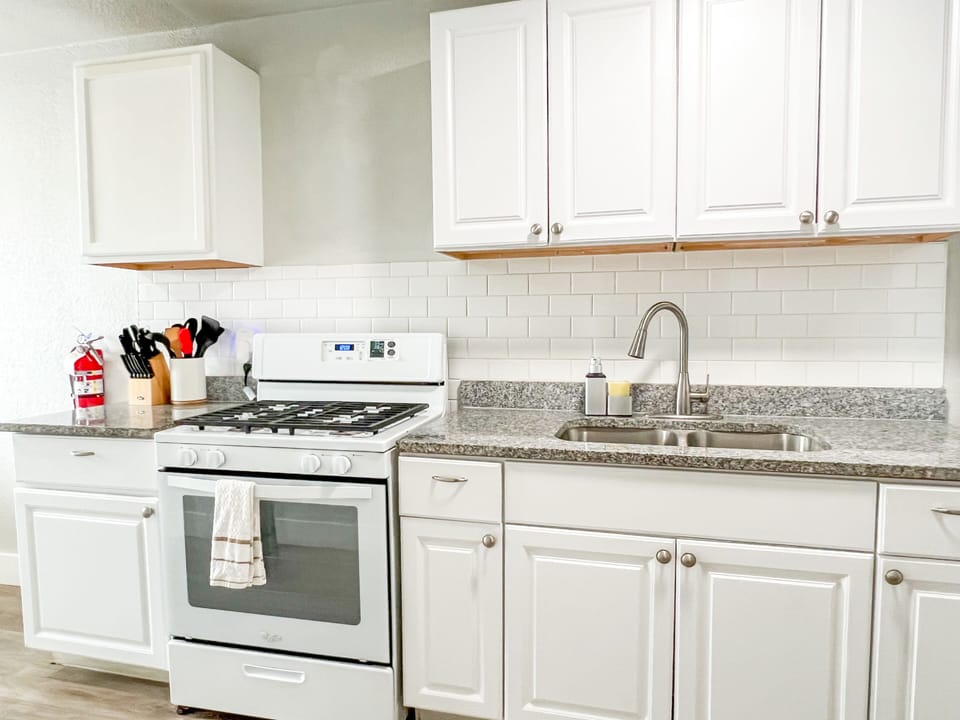 Discover a culinary paradise. Our kitchen is stocked with essentials like pots, pans, knives, cutting boards, and bakeware. Enjoy a gas stove, microwave, toaster, and a 12-cup coffee maker. Plus, enjoy complimentary coffee and sugar for a delicious morning.