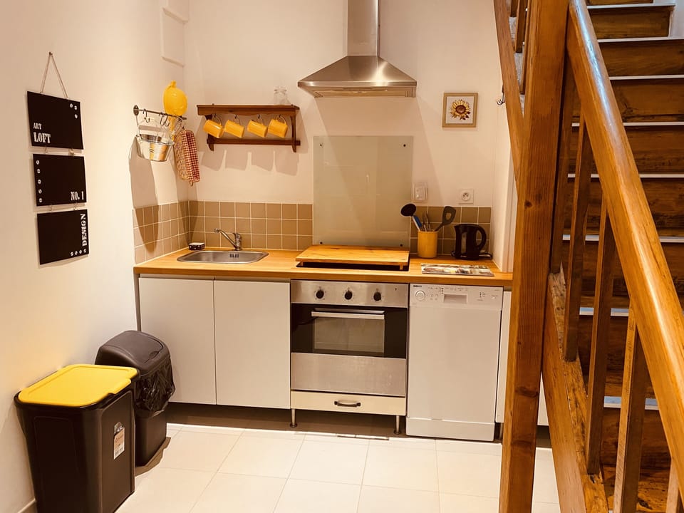Fully equipped kitchen with access to communal laundry area and terraces