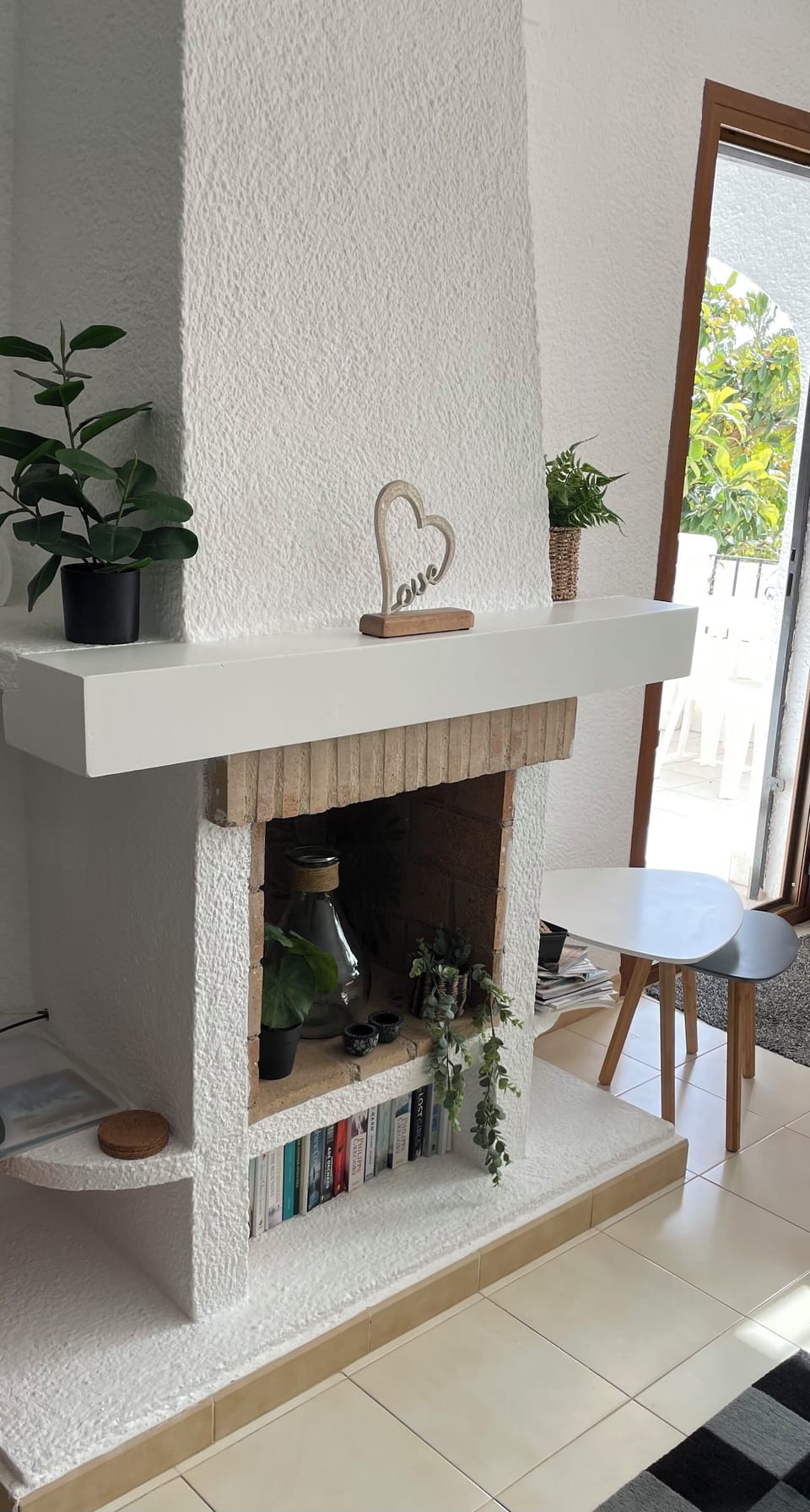 The decorative fire place and showing the door out onto the balcony 