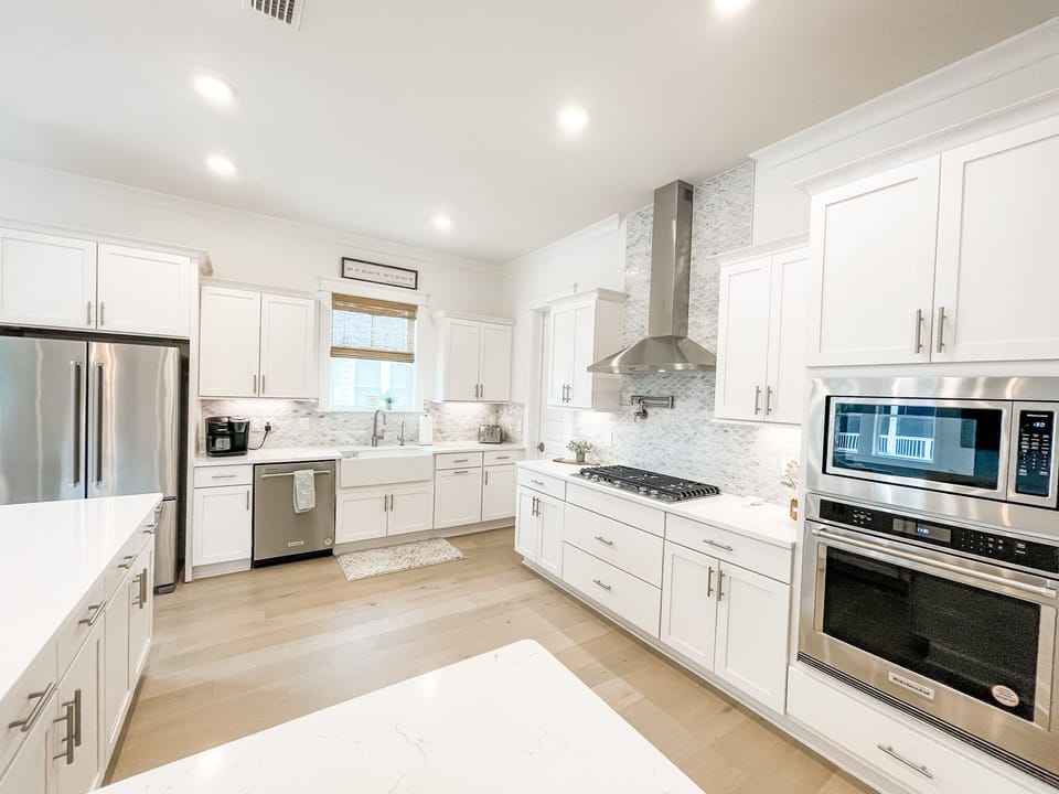 New kitchen with stainless steel appliances and a gas stove. 