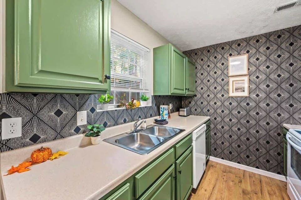 Your fully stocked kitchen awaits you with its sleek, modern design. Enjoy the convenience of a double sink and all the essentials you need to whip up your favorite meals!