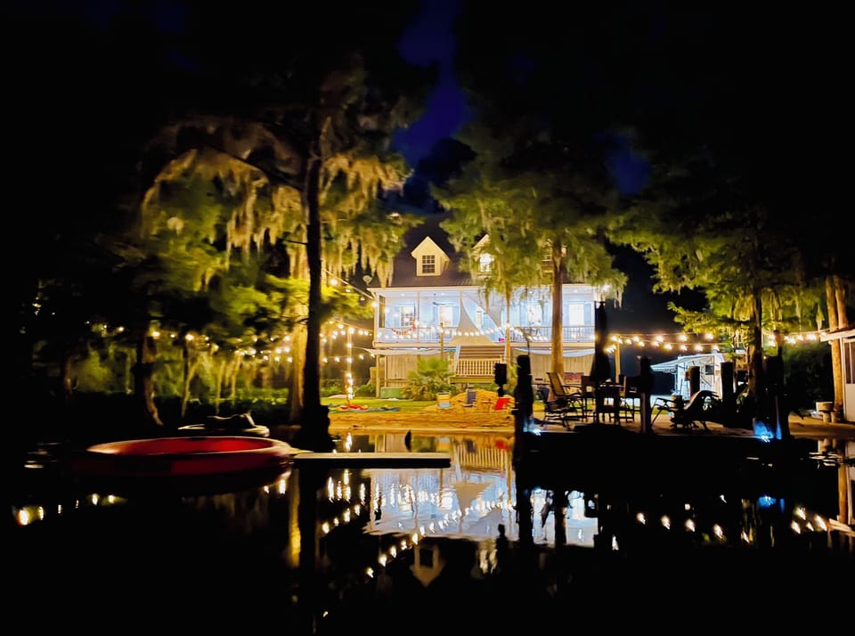 View of back of home with lights