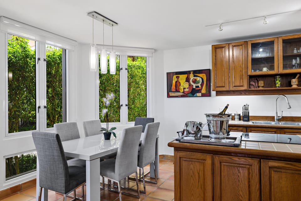 Kitchen is adjacent to a six-seater dining area with a bright bay-window cove.