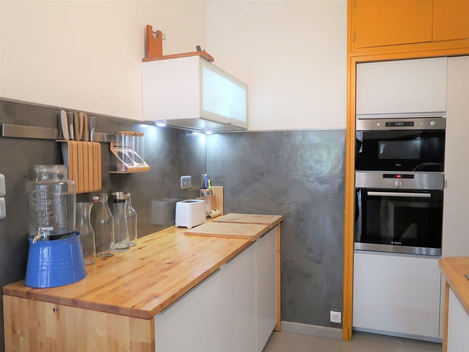 Building, Cabinetry, Countertop, Kitchen Appliance, Kitchen, Kitchen Sink, Kitchen Stove, Lighting, Wood, Home Appliance