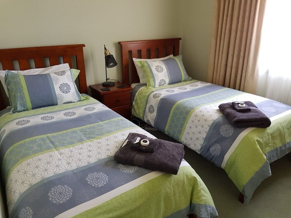 Bedroom 2 with 2 single beds and built in robes