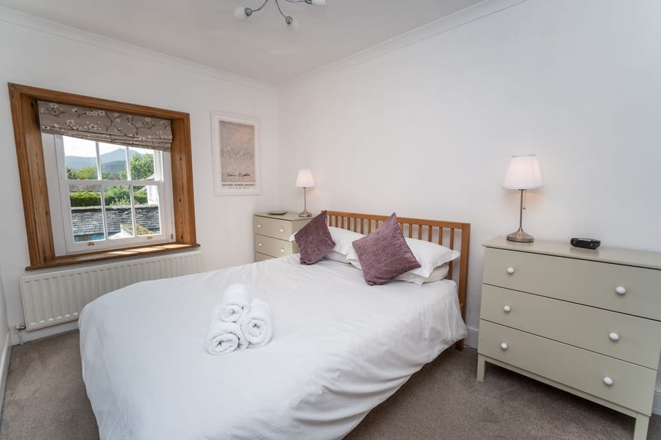 A lovely airy master bedroom with king sized bed