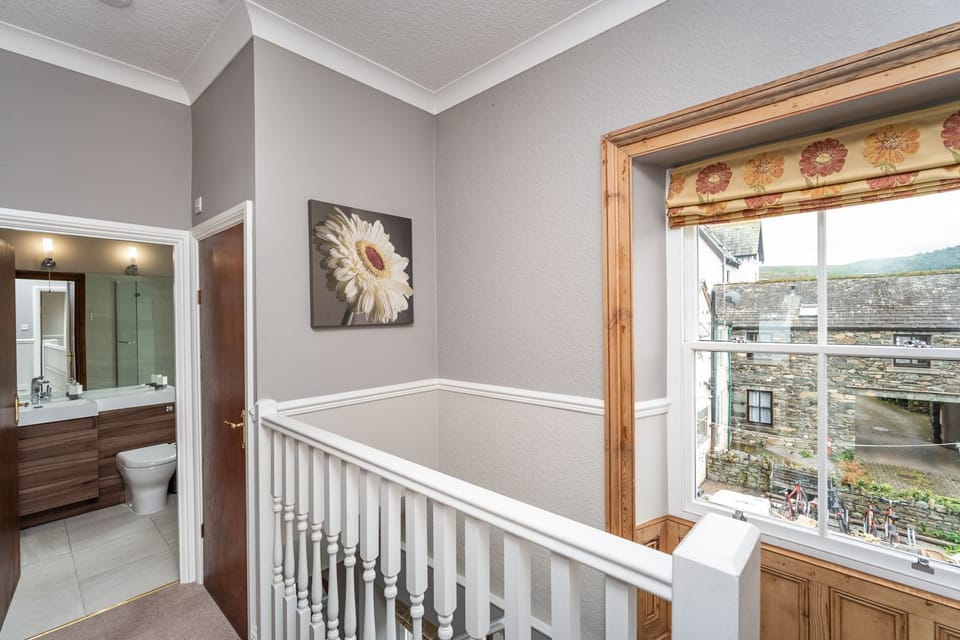 The stairs lead to the hallway, with views over the large courtyard