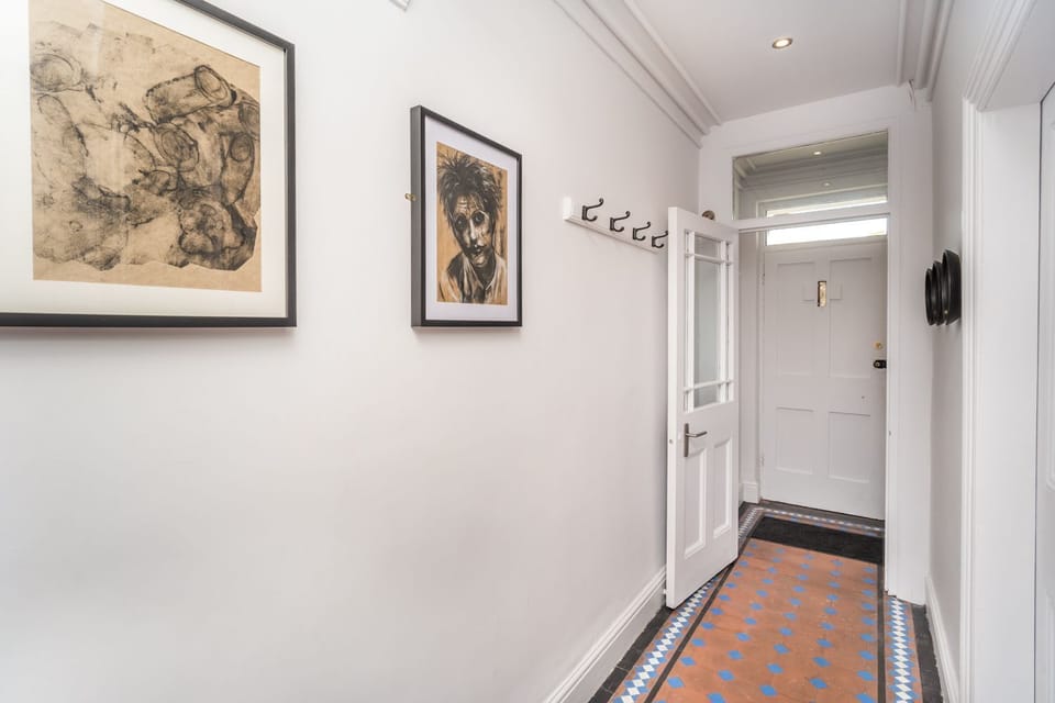 The property retains some original features, including the attractive floor tiles in the hallway