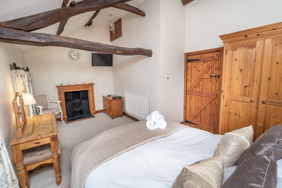 Tonnes of character - the bedroom features original beams and cast iron fireplace