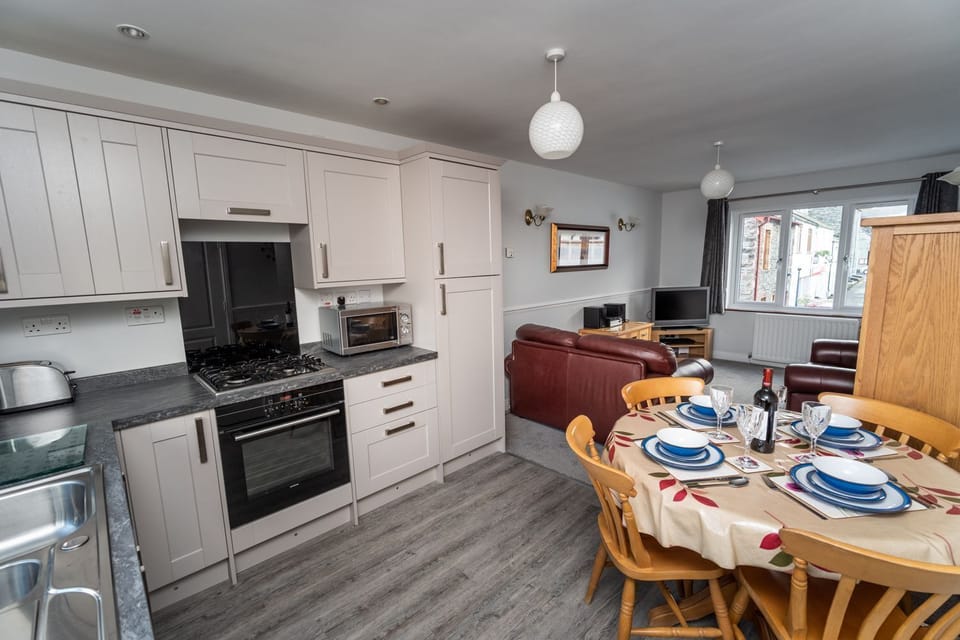 The open plan living area and kitchen is spacious and airy