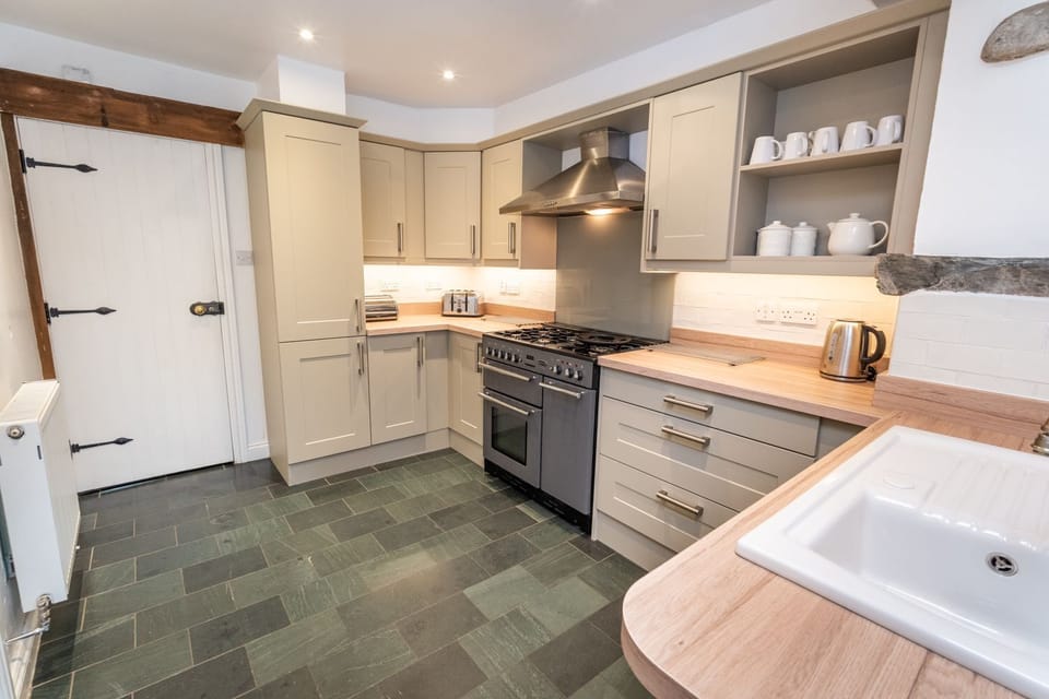 The kitchen has an impressive gas range, oven, dishwasher, fridge/freezer and microwave