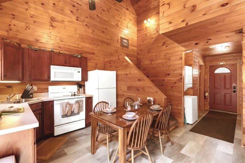 The kitchen is the perfect combination of cozy and convenient, equipped with wood furniture and cabinetry, appliances, and all the cookware, utensils, and dishware you'll need.

Or, open the door to the private patio and enjoy a meal al fresco!