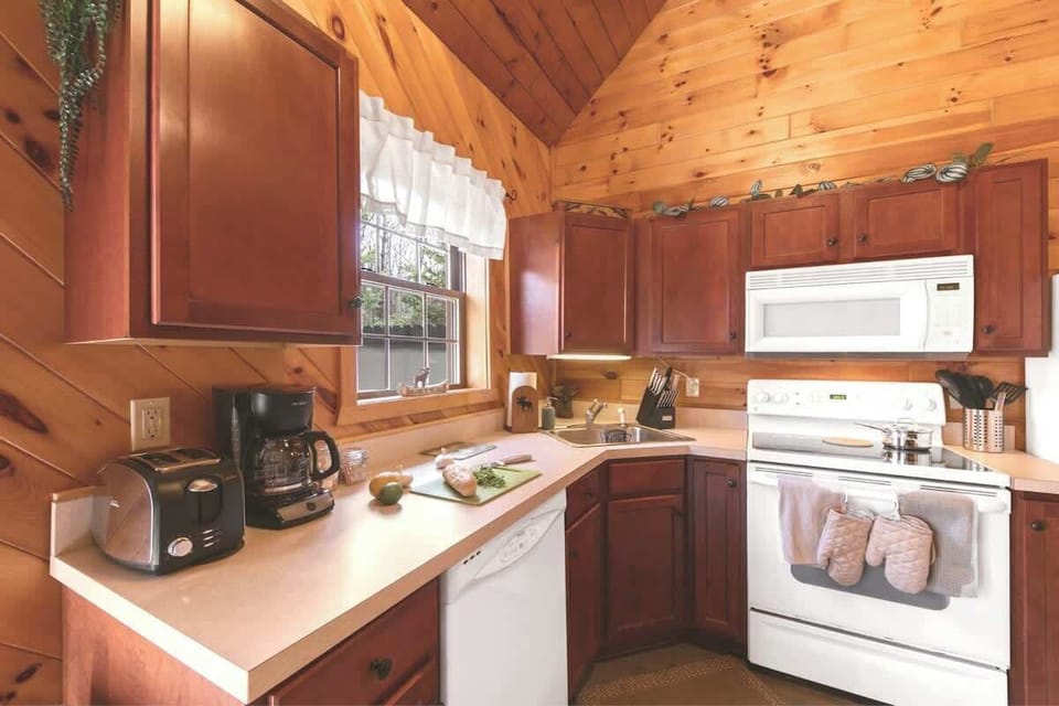 The window in the kitchen looks out over the outdoor patio and lets in sunlight throughout the day.