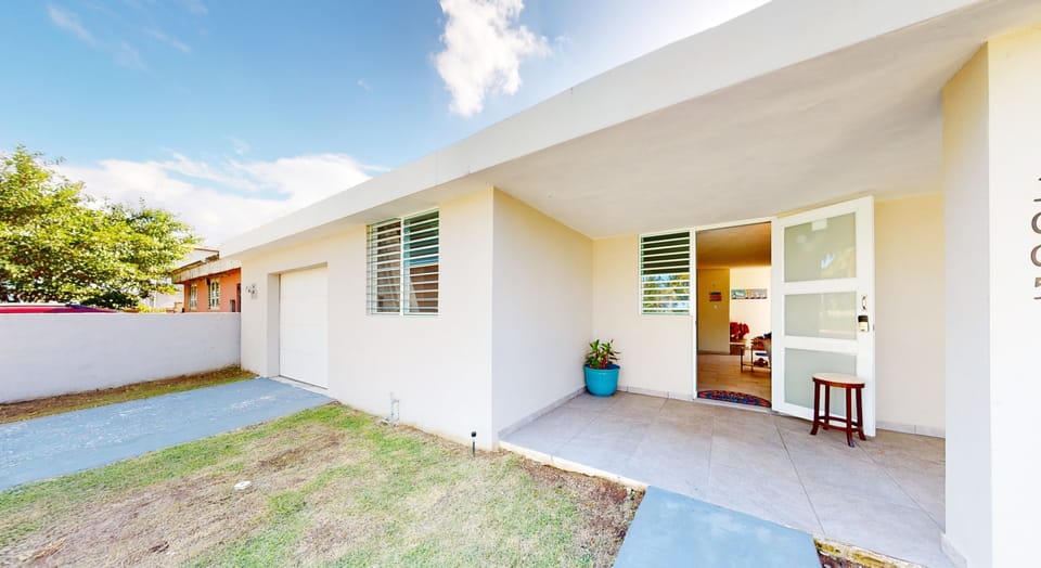 Front view faces the beach, 1-car garage and private driveway.