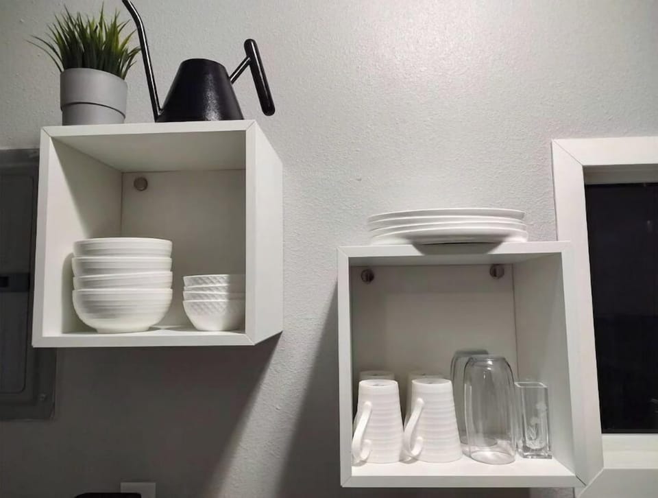 Bowls + plates of varying sizes, as well as mugs and glasses on floating shelves