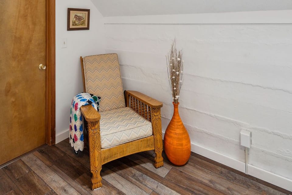 Antique chair from ancestral farmhouse on adjacent property.  Art by our Mom