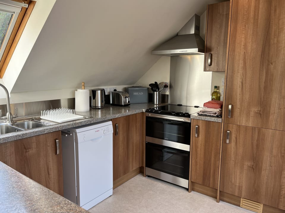 The Loft kitchen with fridge freezer, electric cooker and dishwasher