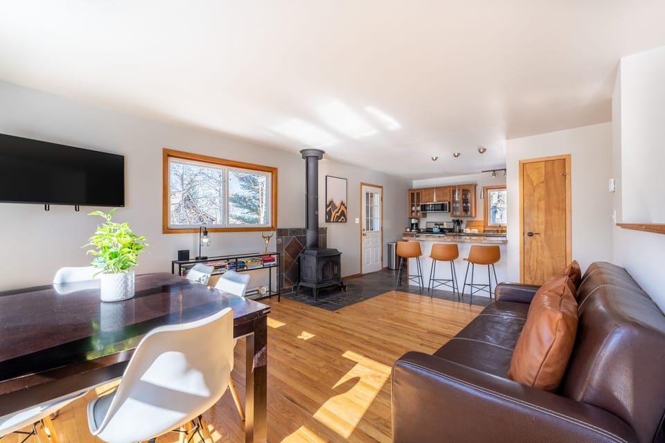 Main level living area offering a mounted Smart TV, surrounding windows, and new furnishings.