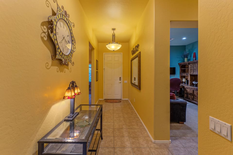 Access the den via the hallway.