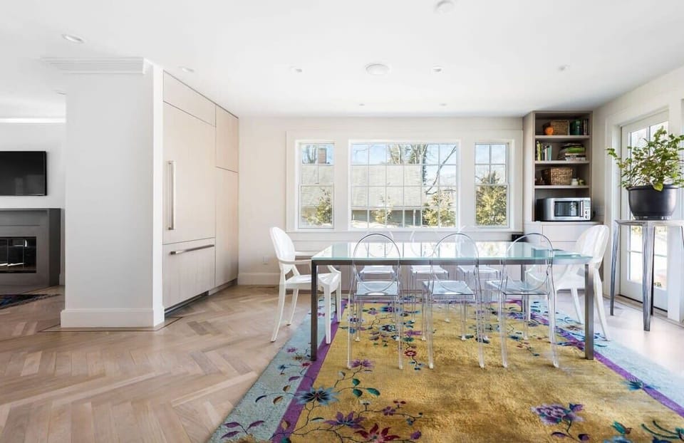 Dining table and beautiful rug surrounded by storage options