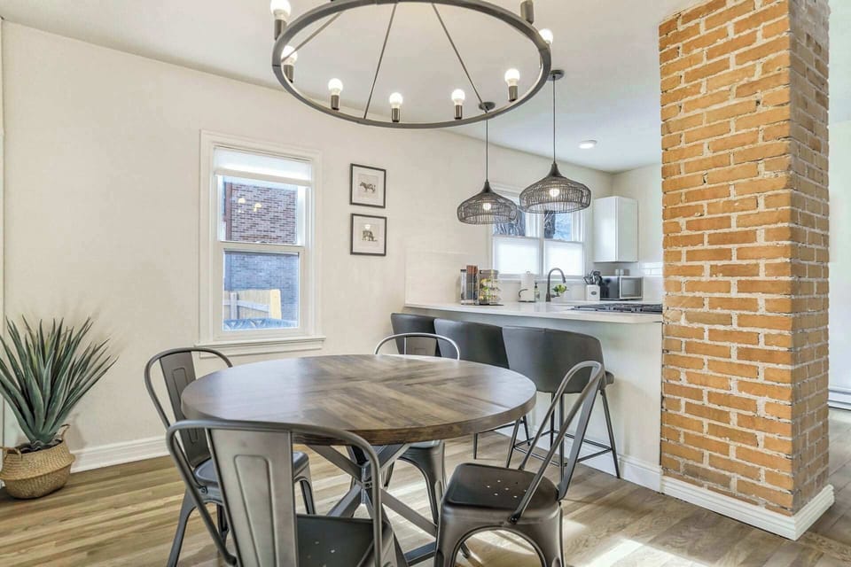 Gather around the dining table for meals and conversation in a cozy setting.