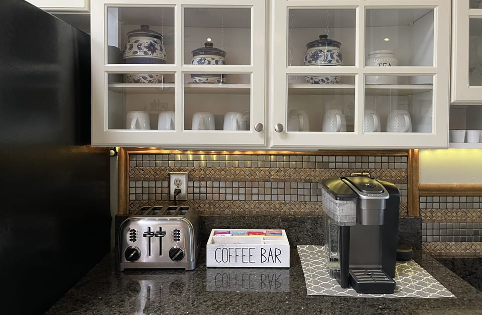 Coffee bar with Keurig coffee machine, coffee, creamers, tea and sweeteners. 
