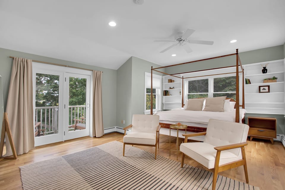 Master bedroom with king size bed and balcony overlooking yard