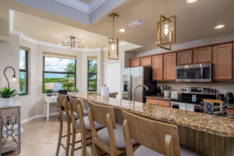 View of the bar in the kitchen and comfortable bar chairs.