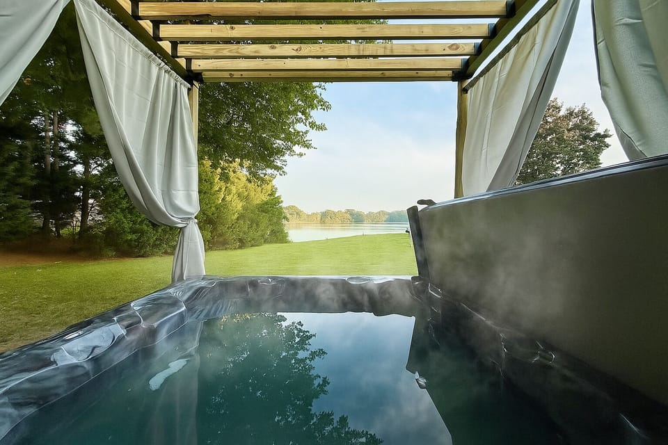 Hot tub with beautiful water views. Off the deck and same level as the home.