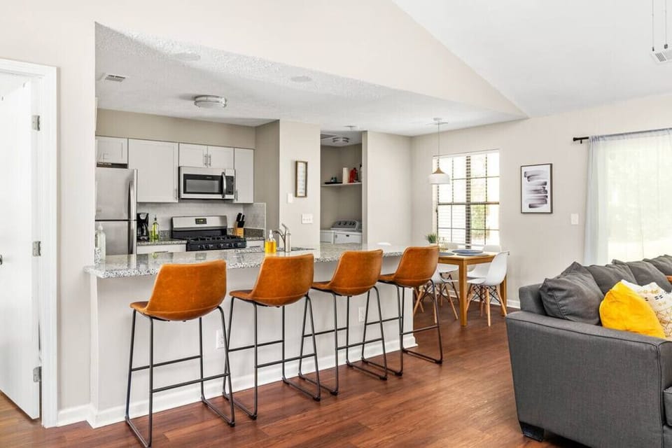 The living area is connected to the kitchen and dining area