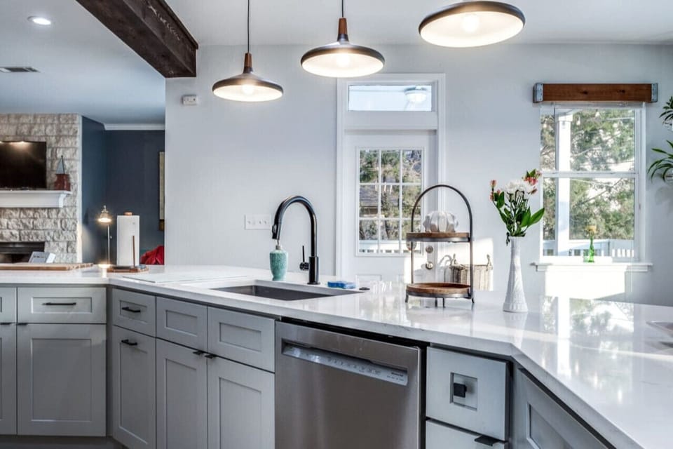 Kitchen island offers storage, dishwasher, sink and bar stools for more eat-in options.