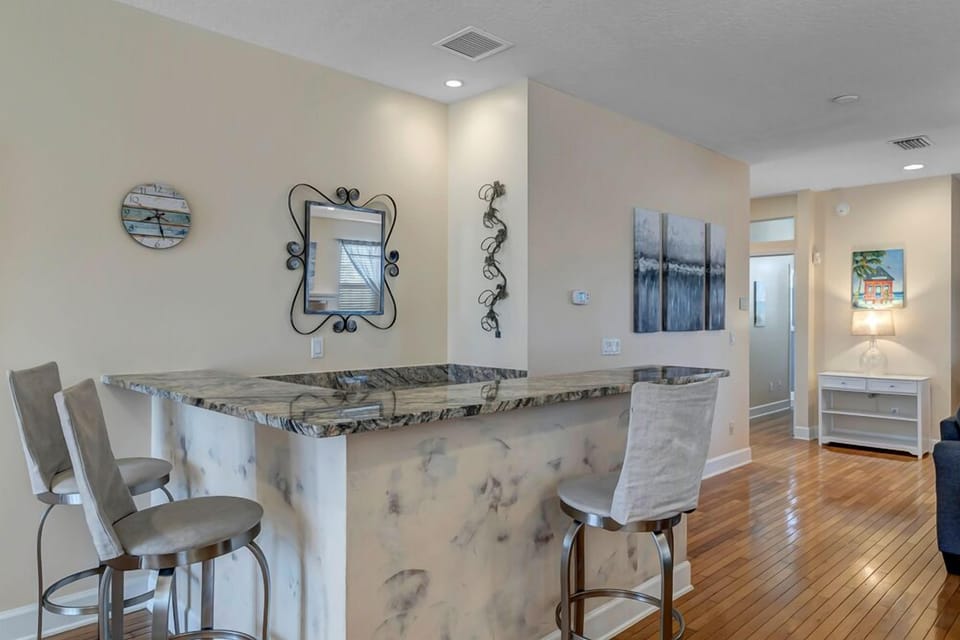 - Enjoy casual drinks or snacks at this granite topped bar with sleek stools and coastal wall art
- Great spot for morning coffee, happy hour chats, or planning your beach adventures
- Built into the layout with style and convenience in mind
