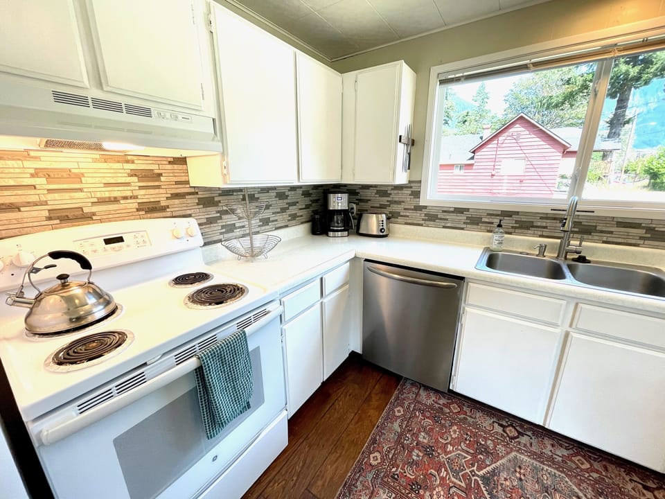 Oven, kettle, coffee maker, toaster, dishwasher, spices, utensils, pots/pans.