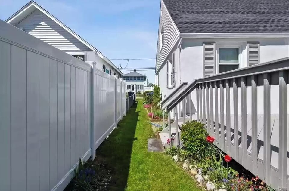 Side of House with outdoor shower to rinse off from the beach.