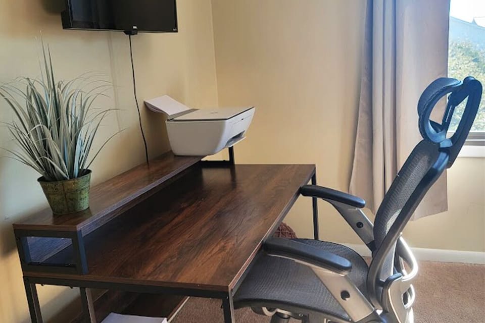 Master bedroom desk, ergonomic chair, printer and TV