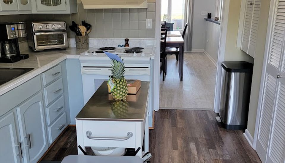 There is a large window in kitchen behind the shot with view to fenced yard.