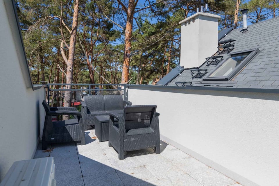 Spacious balcony with outdoor furniture. 