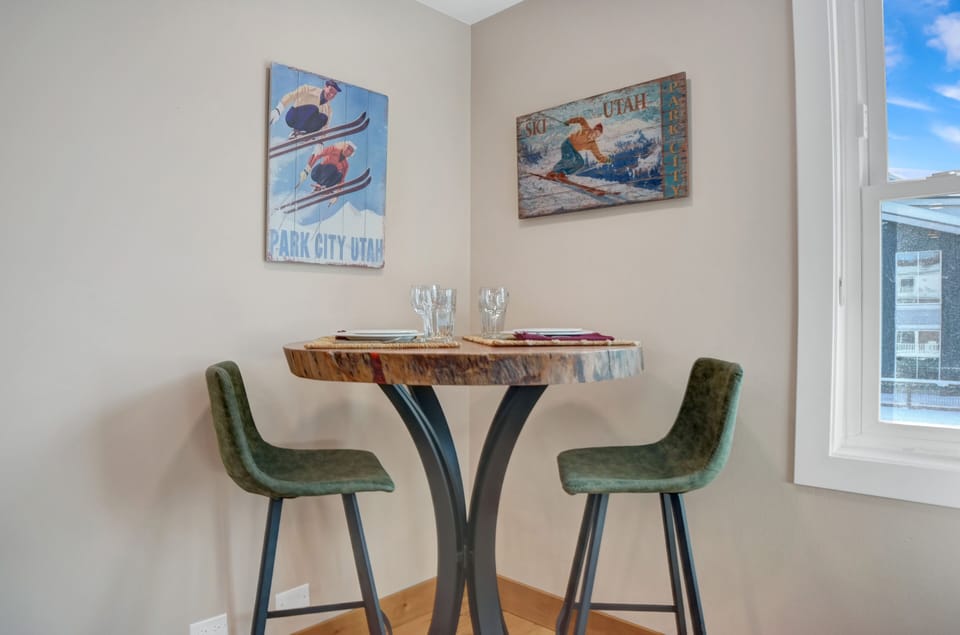 Solid wood bistro table with modern upholstered leather barstools