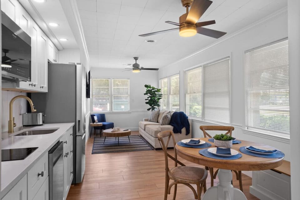 Stylish open living space with fully equipped kitchen, dining area, and sun-filled windows—ideal for families and extended stays
