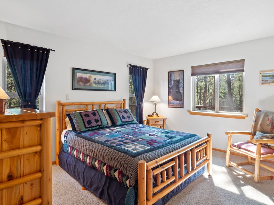 Back bedroom with queen bed and side and back views