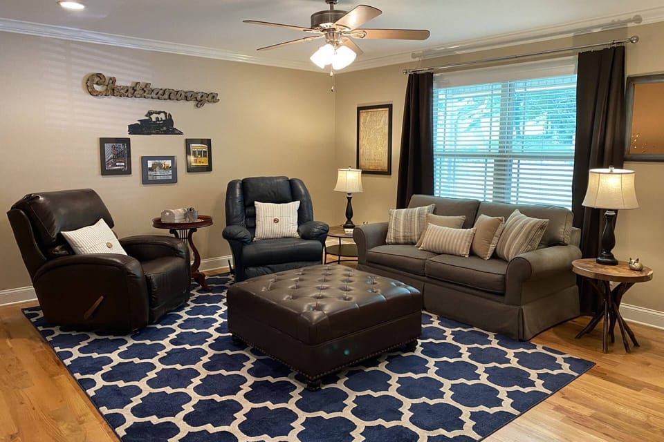 Spacious living area open to kitchen and access to front porch. Includes two recliners and a full size foldout bed in the couch.