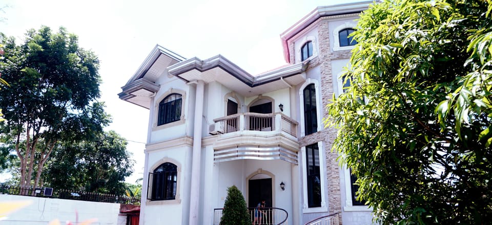 Front of the house, mango to right.