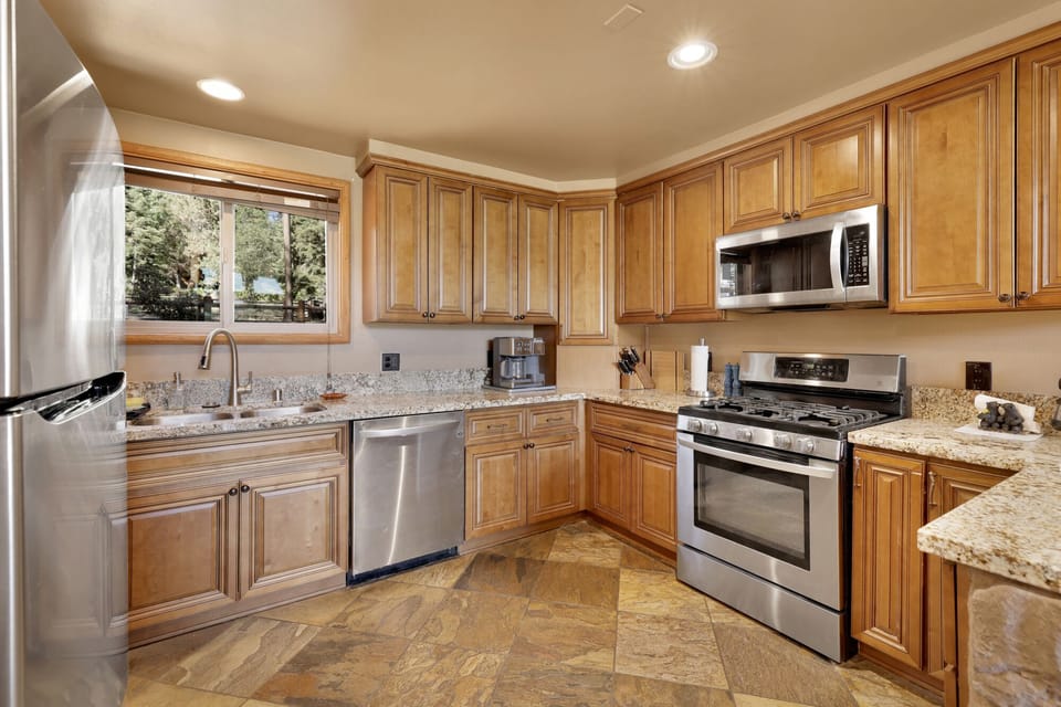 Fully equipped cabin kitchen with ample cabinetry, stove, fridge, microwave, and coffee maker—perfect for cooking meals, morning coffee, and feeling right at home on your stay.