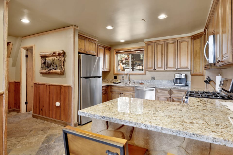 Fully equipped cabin kitchen with ample cabinetry, stove, fridge, microwave, and coffee maker—perfect for cooking meals, morning coffee, and feeling right at home on your stay.