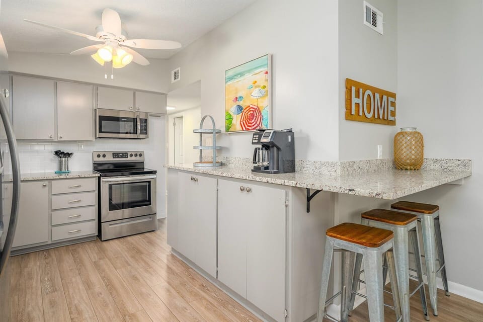 The spacious counter doubles as a casual dining spot, with bar stools perfectly positioned for sipping, chatting, or sharing stories over snacks.