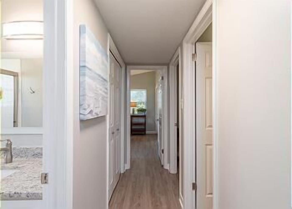 All three bedrooms and bathrooms are conveniently located off the home's main hallway, offering easy access and a thoughtful layout.