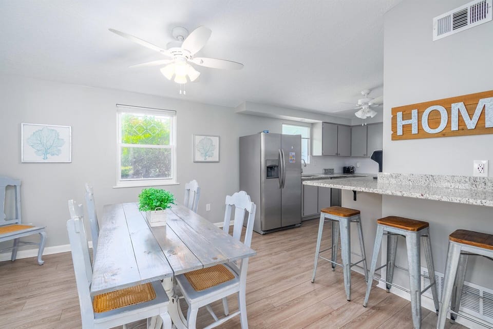 An open dining area seamlessly overlooks the kitchen, inviting lively conversation and effortless entertaining