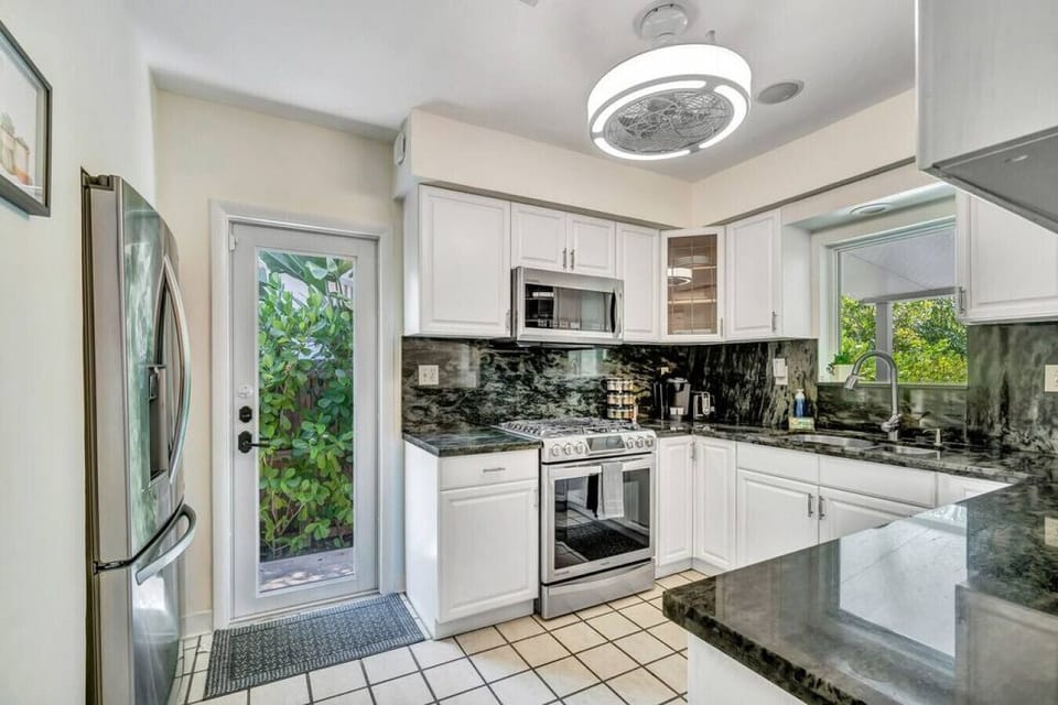 `Stainless steel, marble, and good vibes - this kitchen is ready to cook up something delicious (and maybe a little bit fancy).`