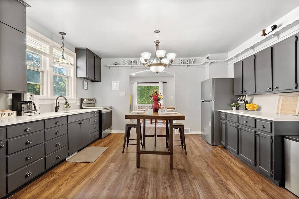 New quartz countertops and stainless steel appliances showcase the large kitchen.