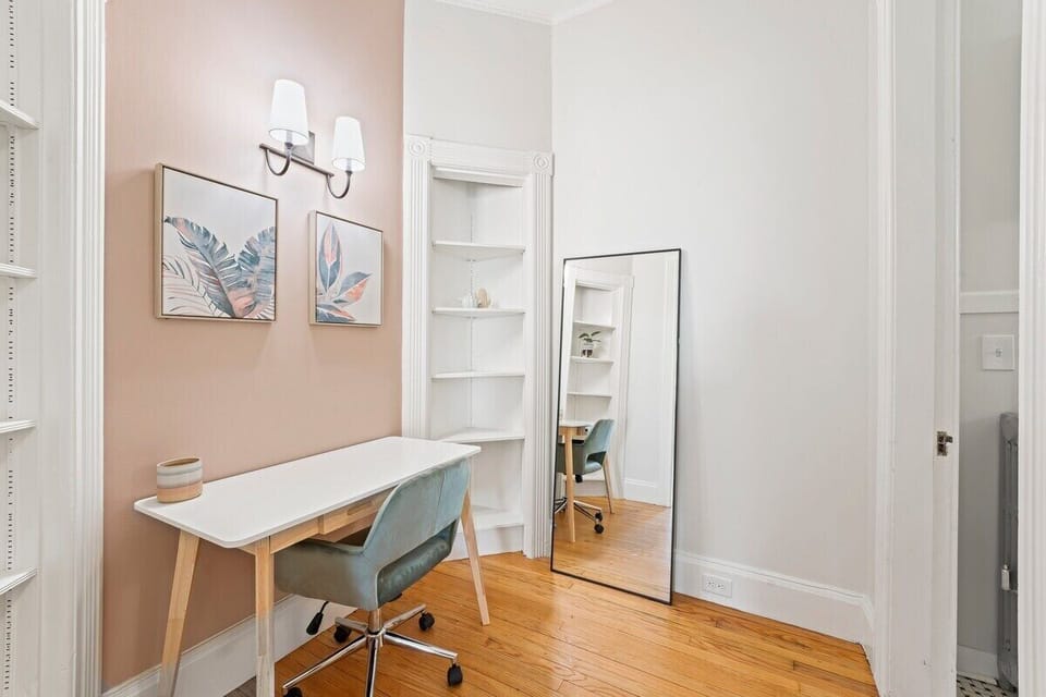 Office nook with open shelving and a full length mirror